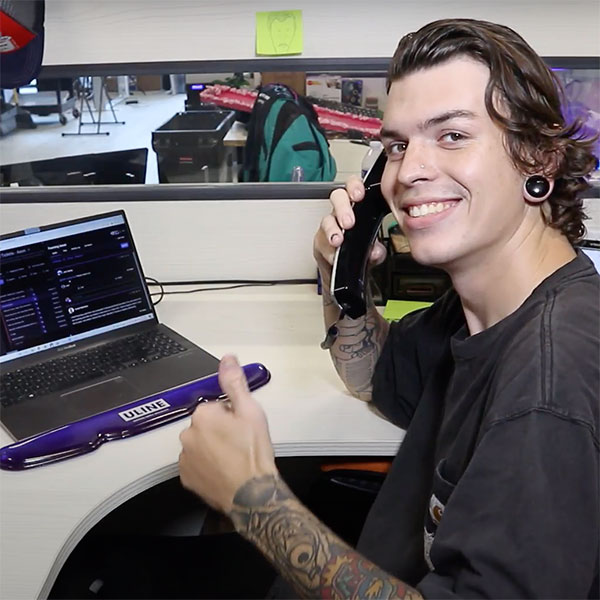 a customer support agent holding the phone and smiling