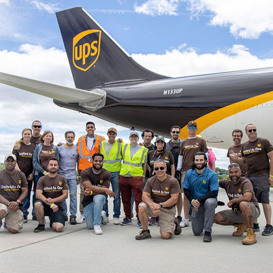 UPS airplane with a crowd of people posing in front of it