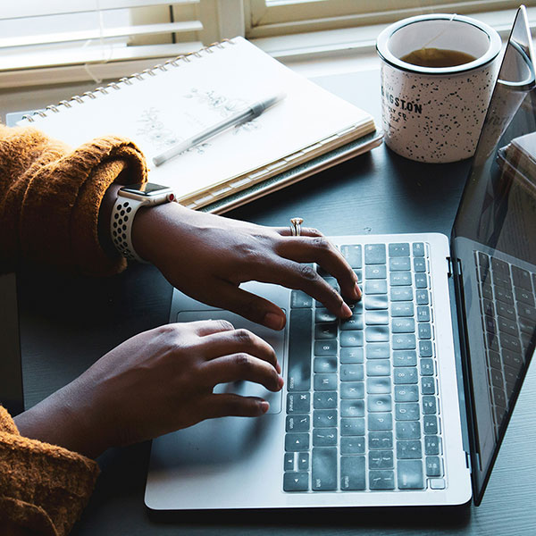 person typing on a laptop, photo by Daniel Thomas